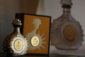 A bottle of 100 numbered handcrafted Crystal Liquor Bottles named "Henri IV���Gold & Silver", dipped in Yellow Gold and Sterling Silver, is seen during a presentation in Mexico City February 22, 2008. Each Bottle with an approximate weight of 6 kg (13.23 lbs.) , it is filled with 100 cl. of Dudognon Heritage Cognac Grande Champagne, aged in barrels for more than 100 years to produce an alcohol content of 41%. Each piece is valued at 9,000 Pounds Sterling ($17,503), Altamirano, the chief executive of the company said. REUTERS/Henry Romero (MEXICO)